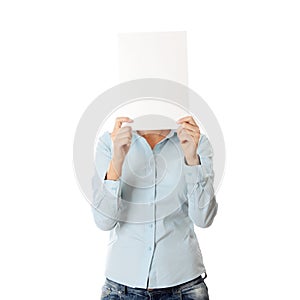 Girl covering her face with blank board