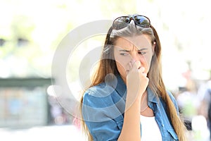 Girl covering nose in a contaminated city photo