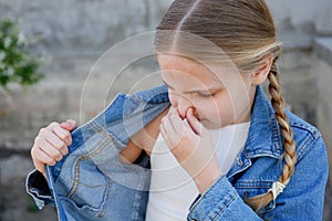 The girl covers her nose. The child does not like the unpleasant smell