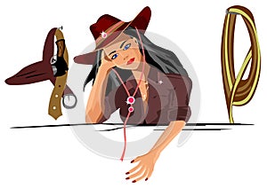 Girl cowboy stands and looks pensive look on the wall hangs a gun and a rope lasso