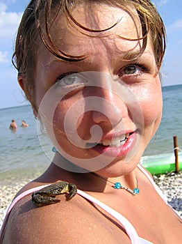 Girl with a crab on a shoulder