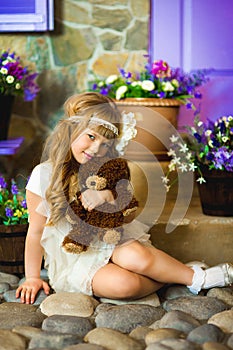 The girl in a cream dress with lilac flowers