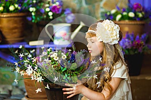 The girl in a cream dress with lilac flowers