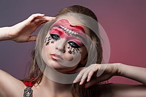 Girl with creative make-up on her face