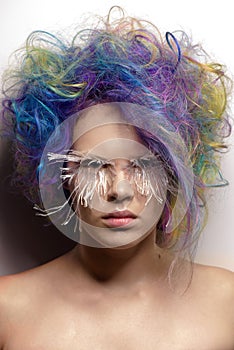 Girl with creative make up, very long false eyelashes and professional hair colouring