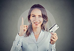 Girl with credit card holding finger up