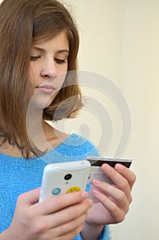 Girl with credit card. Shopping in the online shop