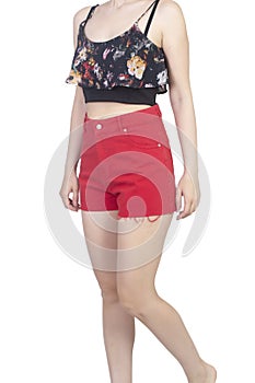 Girl in a crop top and red mini shorts with floral pattern  on white, body part, isolated on white photo