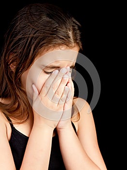 Girl crying and hiding her face