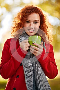 Girl with cup of coffee in autumn