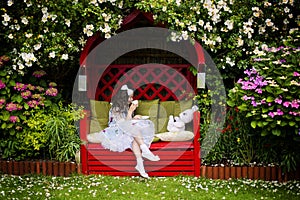 Girl with a cup of tea in garden