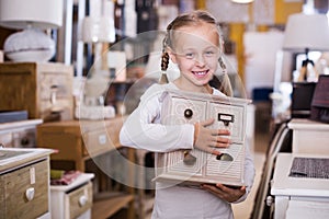 Girl with curbstone in furniture store