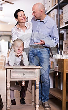 Girl with curbstone in furniture store