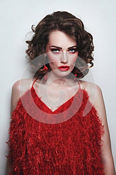 Girl with curly hair and fancy red makeup