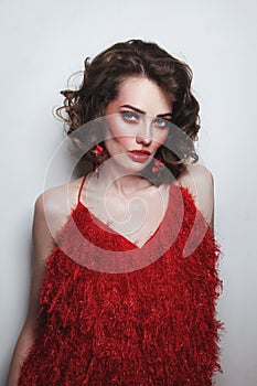 Girl with curly hair and fancy red makeup