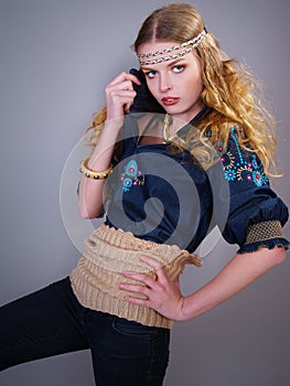 Girl with curly hair in fashionable clothes