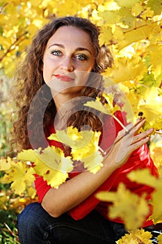 Girl with curly hair in yellow grape vineyard