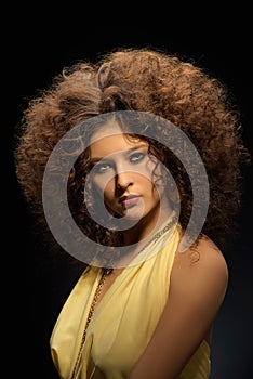 Girl with a curly hairstyle, modern make-up and carnivore look