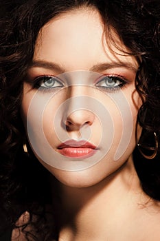 Girl with a curly hairstyle, modern make-up and carnivore look