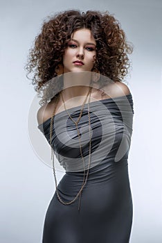 Girl with a curly hairstyle, modern make-up and carnivore look photo