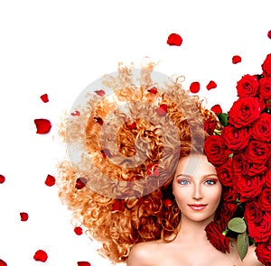 Girl with curly red hair and beautiful red roses