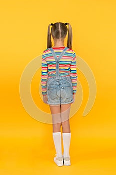 Girl cute child long hair double ponytails hairstyle rear view. Prevent split ends. Treatment hair breakage. Beauty