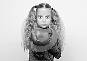 Girl cute child with red gloves posing on white background. Cute kid with sport boxing gloves. Boxing sport for female