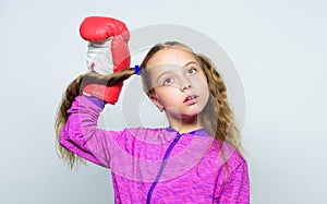 Girl cute child with red gloves posing on white background. Sport upbringing for leader. Cute kid with sport boxing