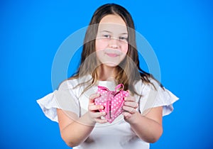 Girl cute child show heart toy. Heart symbol of love. Kid adorable girl happy face show heart blue background. Celebrate