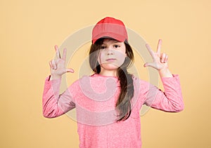 Girl cute child wear cap or snapback hat beige background. Little girl wearing bright baseball cap. Modern fashion. Kids