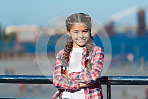 Girl cute kid with braids relaxing urban background defocused. Organize activities for teenagers. Vacation and leisure