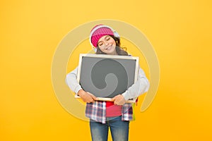 Girl cute little child wear headphones listen music hold chalkboard copy space. Small kid listen music. Global fandom