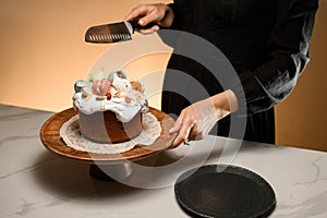 Girl cutting Easter on a rustic wooden stand