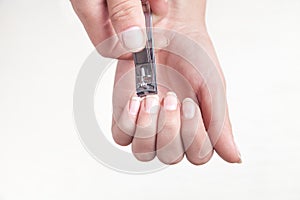 Girl cutting fingernails using a nail clipper