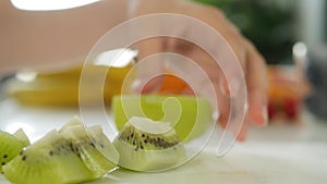 Girl Cutting Kiwi Fruits for Smoothie, Young Woman Preparing Fruit Exotic Salad, Cooking Breakfast in Kitchen, Healthy Nutrition