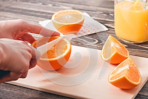 Girl Cutting Orange with Knife. Healthy Lifestyle Concept