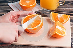 Girl Cutting Orange with Knife. Healthy Lifestyle Concept