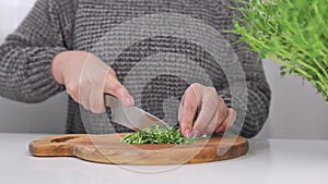 A girl is cutting pea sprouts. Close-up