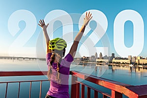 Girl cyclist in a helmet at the finish