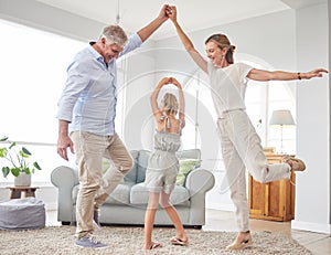 Girl dance with grandparents on living room, have fun and happy time in home. Senior man, smile in house with woman and