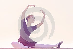 Girl dancer doing different movements of dance in bathing suit for dancing and ballet shoes