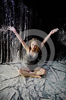 Girl dancer jumping and dancing on a black background.