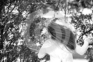 Girl dancer with long flying hair. Kid dance to music in summer park. Small child enjoy music in headphones outdoor