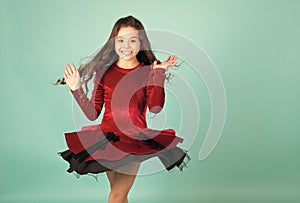 Girl dancer spin in red dress blue background