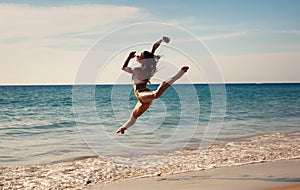 The girl dances at sunset on the seashore