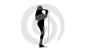 Girl dances to the beat of her song. White background. Silhouette. Side view. Slow motion