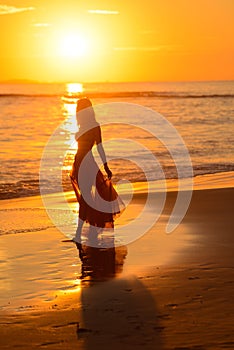 Girl dancing on the beach at sunset,mexico