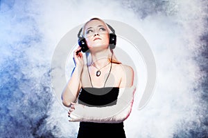 Girl dancing with broken arm and headphones