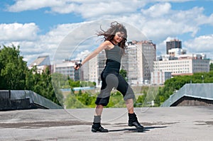 Girl dancing hip-hop over urban landscape