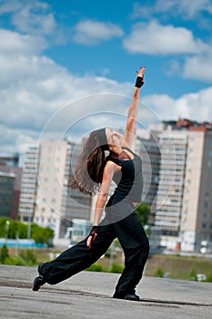 Girl dancing hip-hop over urban landscape